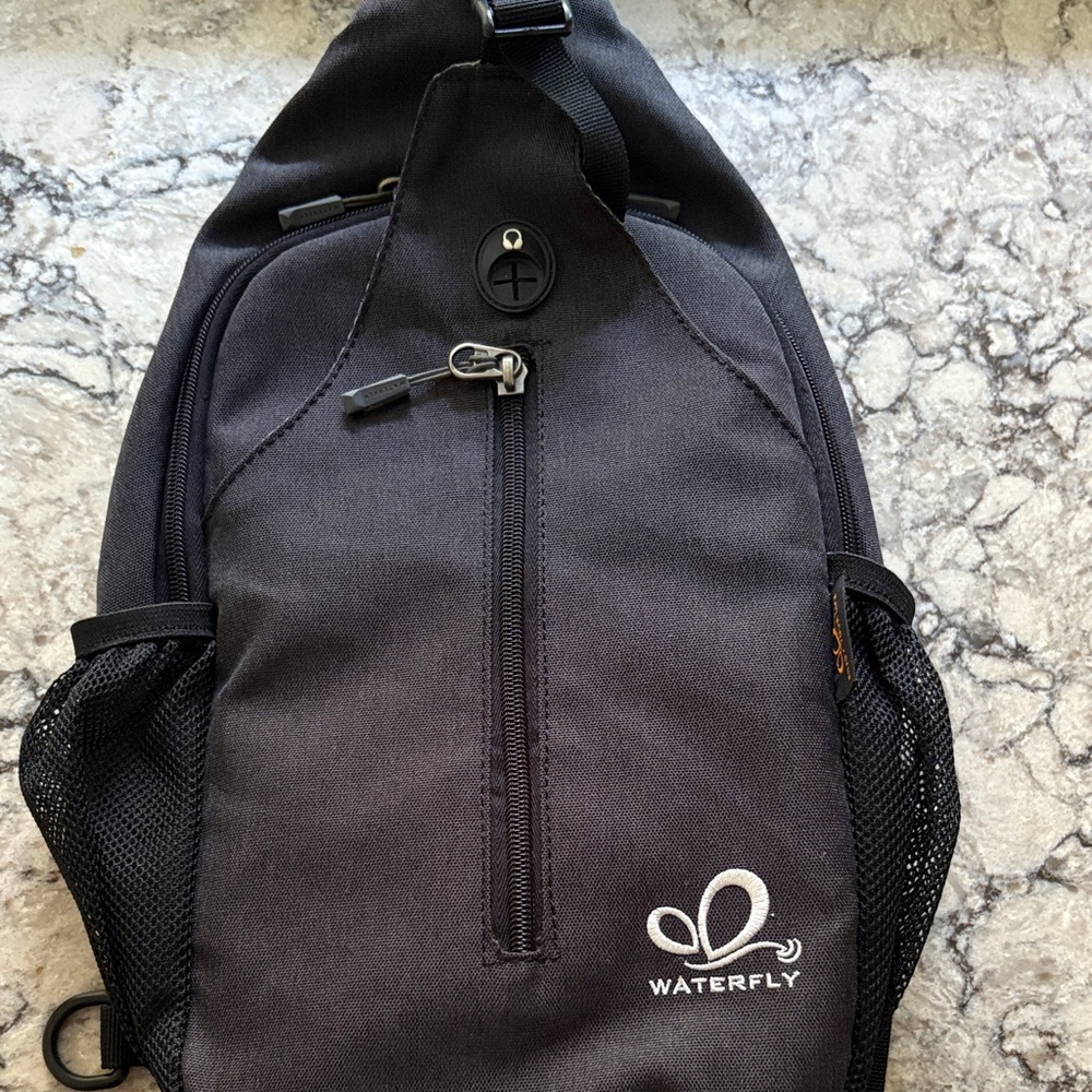 Black Crossbody Sling Backpack by Waterfly